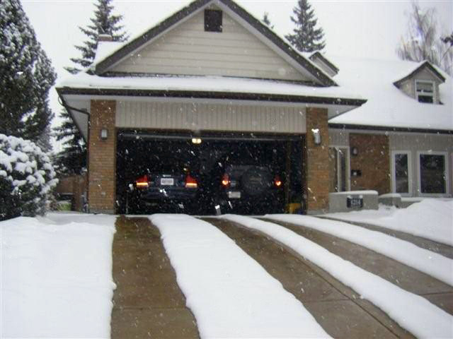 A radiant heated driveway with heated tire tracks.